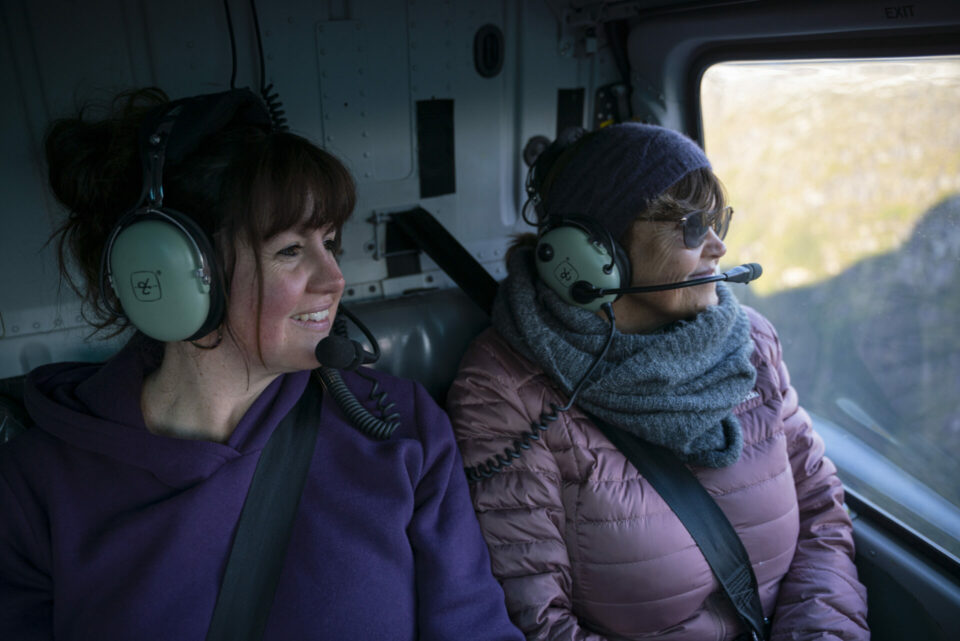 Two women sitting in a helicopter